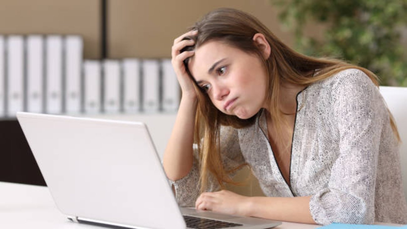 image of unhappy woman staring at a computer screen